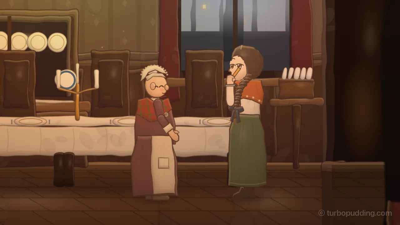 The dining room of the villa in warm lamplight: Omīte, a small grandmother in round glasses, a white lace cap, a red plaid shawl and a long plum dress with a cream apron, stands with her hands folded and her eyes closed in a smile as she talks, while Daina, in a cream blouse, an orange shawl and a long green skirt, a long dark plait over her shoulder and a pencil tucked behind her ear, listens with her fist at her mouth, biting a finger. Behind them are a long white tablecloth, tall dark chairs, a rack of plates, a candlestick and a window onto a gray evening.